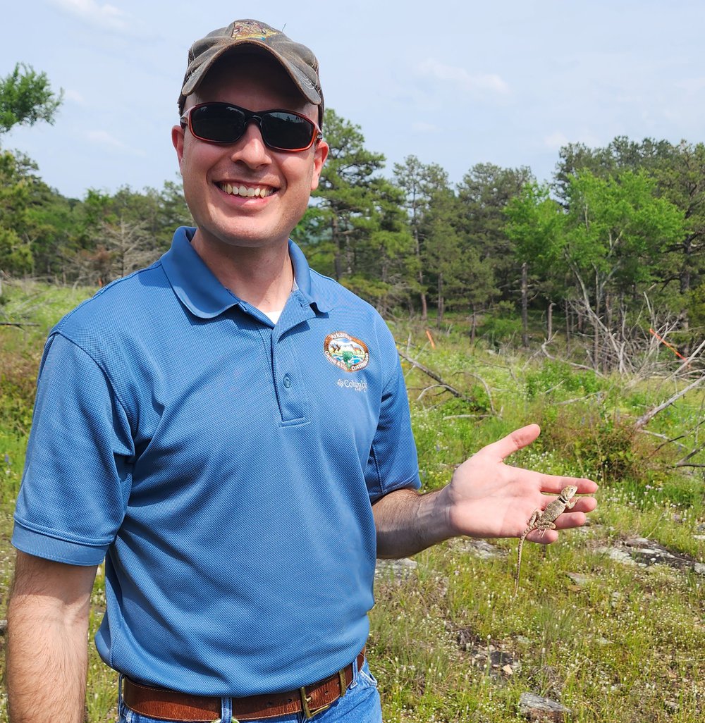 AGFC Assistant Regional Wildlife Supervisor Levi Horrell with one of many yearling lizards released during last week’s reintroduction effort.